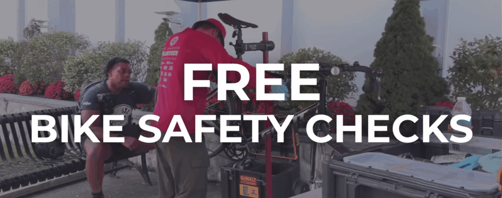 A man checking a bike.