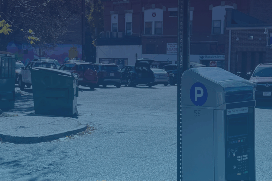 Parking meter in front of parking lot