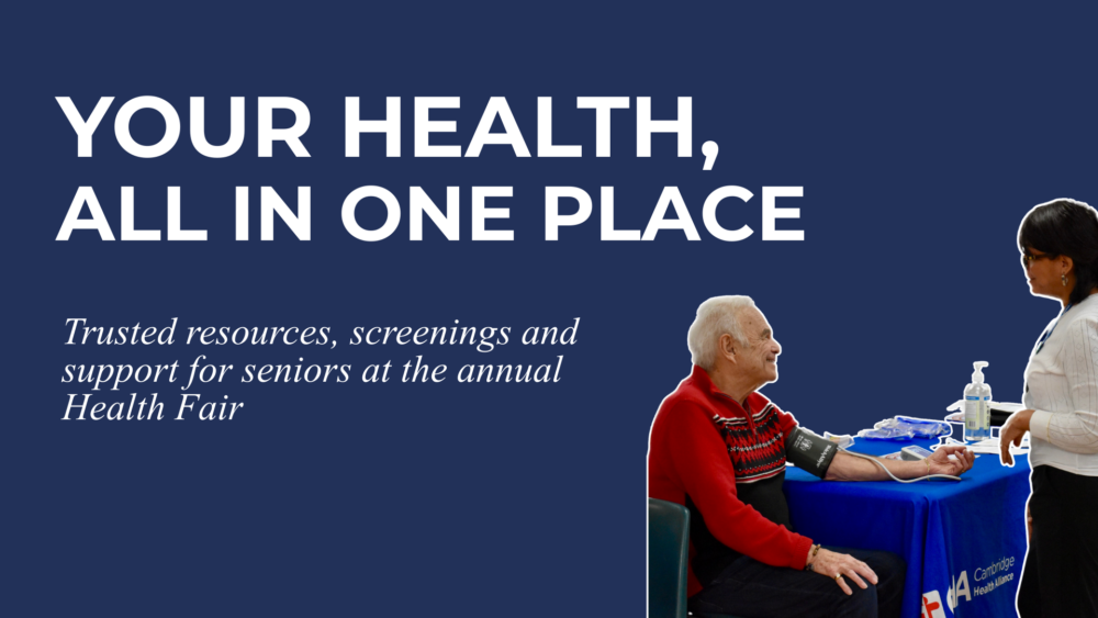 Graphic with the headline “Your Health, All in One Place” and the subheading “Trusted resources, screenings and support for seniors at the annual Health Fair.” On the right, an older adult man in a red sweater smiles while having his blood pressure checked by a healthcare worker at a table with medical supplies and a Cambridge Health Alliance tablecloth.