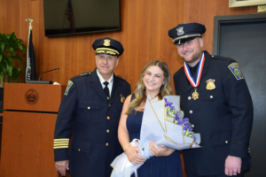Det. Wall standing with his wife Demetria and Chief Strong