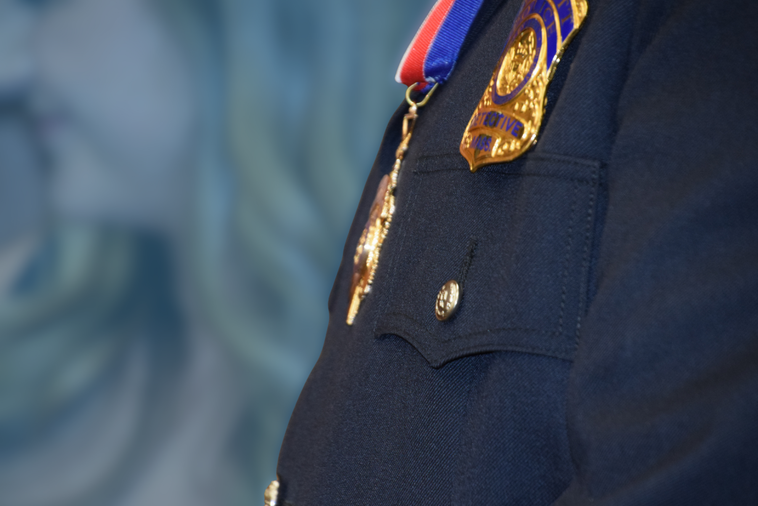 A close up picture of Detective Dan Wall's medal of valor hanging around his neck