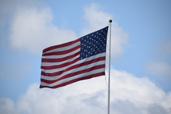 American flag blowing in the wind on a cloudy day