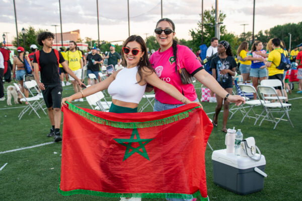 Morocco fans pose with Moroccan flag after the game.