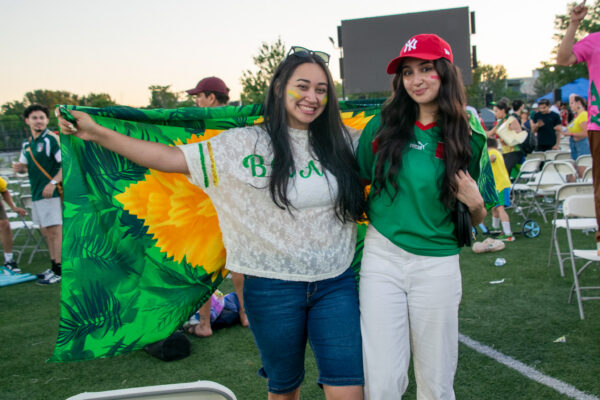 A Brazil fan and Morocco fan pose together after the game.