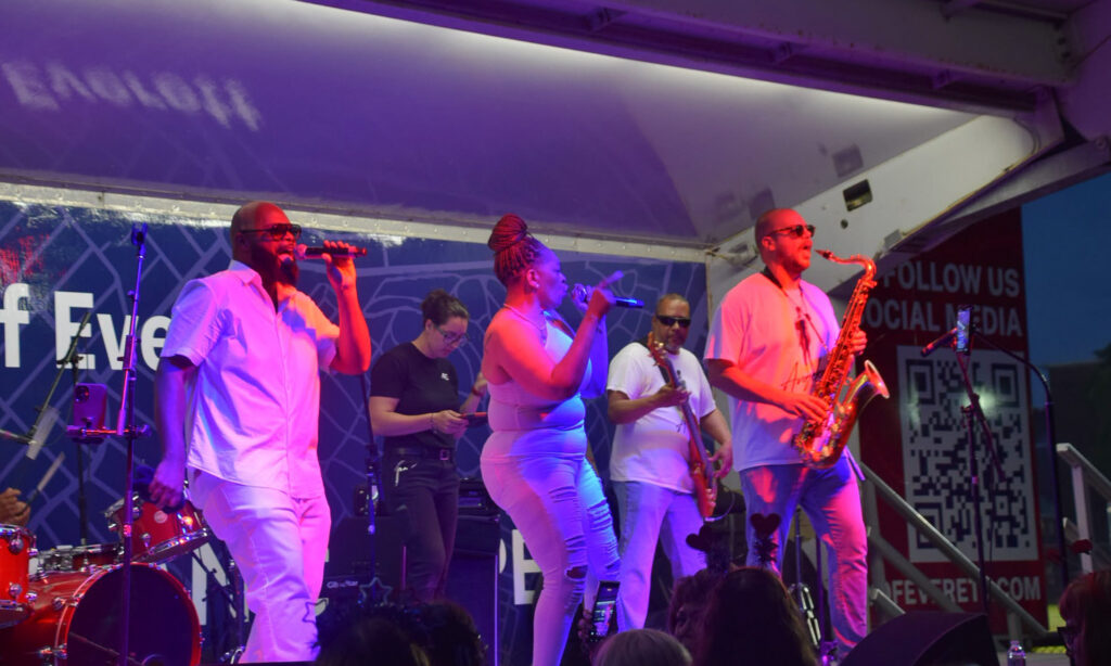 Band performs on stage at celebration.