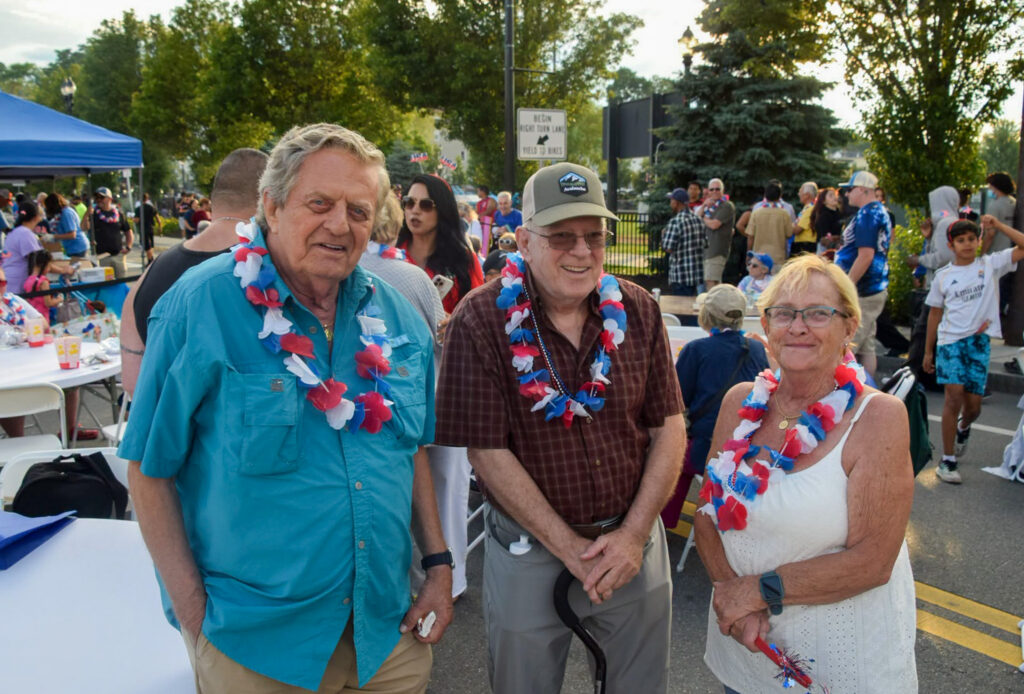 Residents smile and pose in front of eating area.