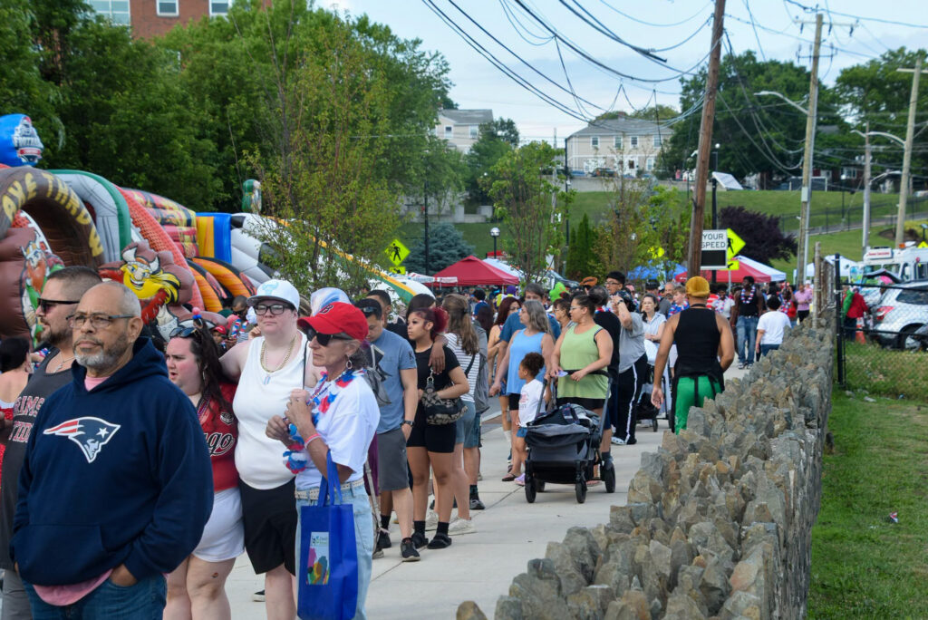 People line up to get free food at the celebration.