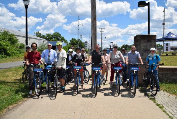 Group photo of Mayor Van Campen, members of MassDOT and community partners outside in the sun on the Northern Strand trail