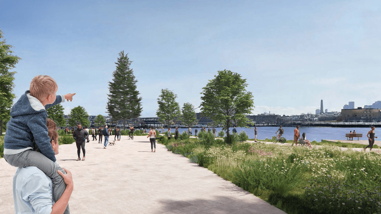 A render of the waterfront park with a pedestrian walkway, trees, and water transport on the river.