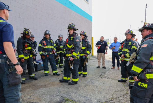 Firefighters with Mayor Van Campen in background