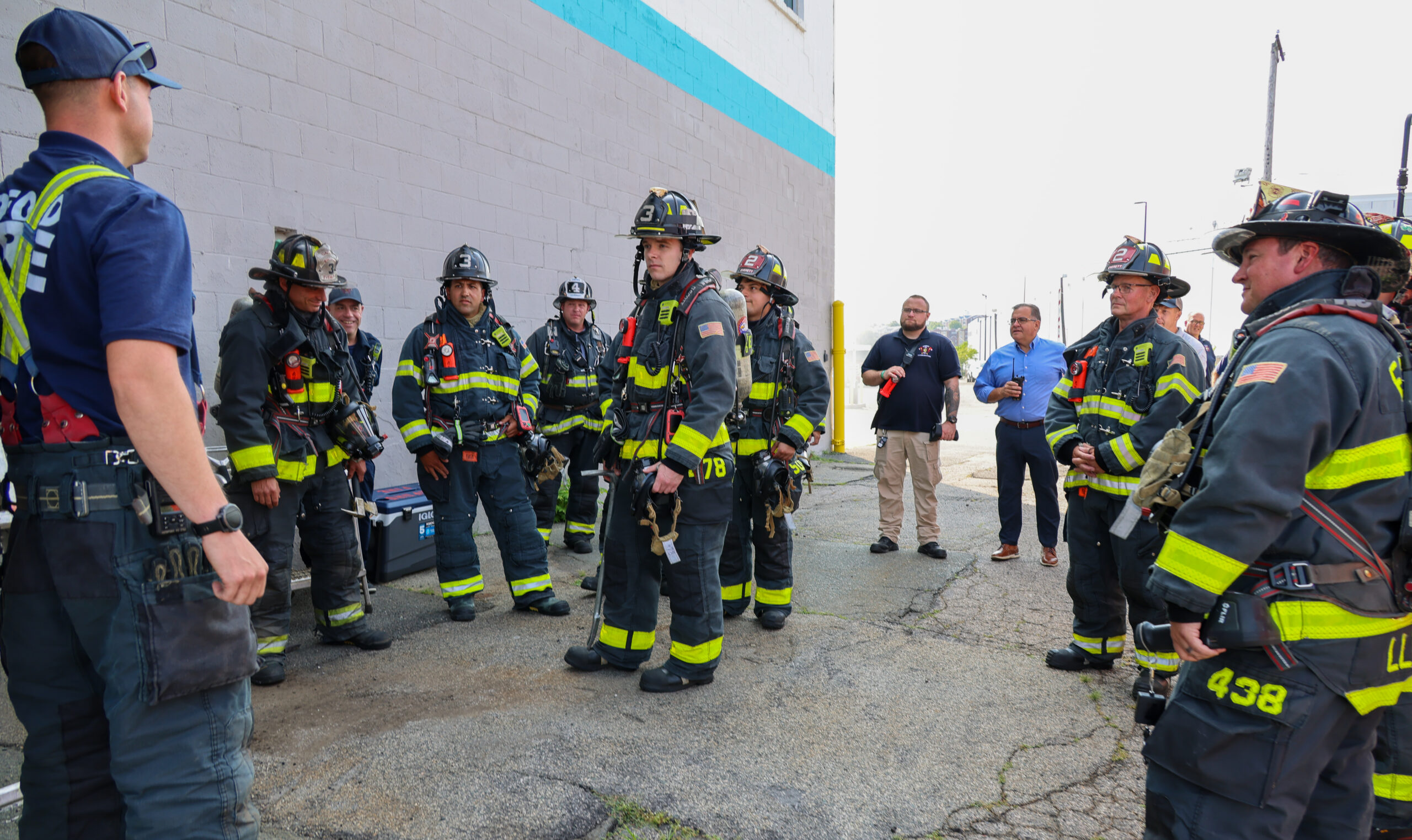 Firefighters with Mayor Van Campen in background