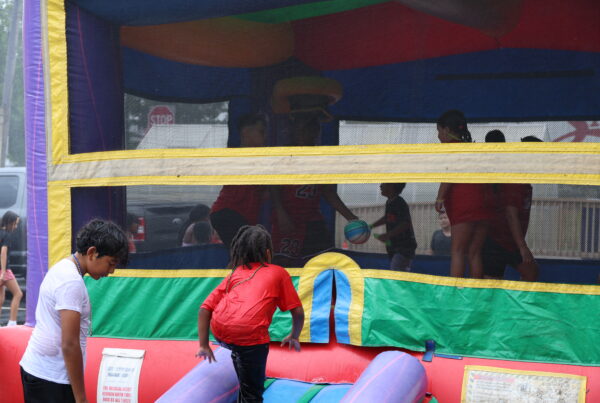 Kids playing in bouncy house at Crimson Kids Summer Program